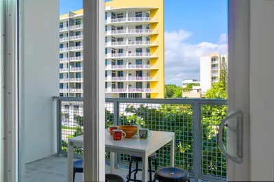 a balcony with a table and a view of a building at Contemporary Condo in Wynwood w Free Parking in Miami