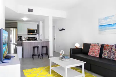 a living room with a couch and a table at Contemporary Condo in Wynwood w Free Parking in Miami
