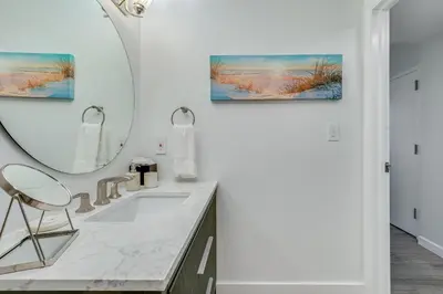 a bathroom with a sink and a mirror at Elegant 2BR Condo at Hotel Arya Full Kitchen Wraparound Views 2 Parking Spots in Miami