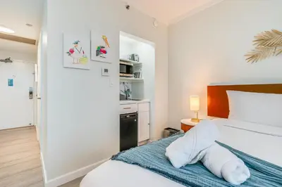 a bedroom with a bed with a towel animal on it at Stylish Studio King Bed City View Hotel Perks Parking in Miami