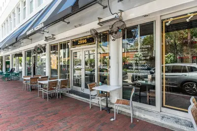 a restaurant with tables and chairs outside of a building at Stylish Studio King Bed City View Hotel Perks Parking in Miami
