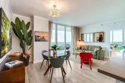 a living room with a table and chairs and a couch at Bright 1BR in Coconut Grove King Bed Views Pool and Parking in Miami