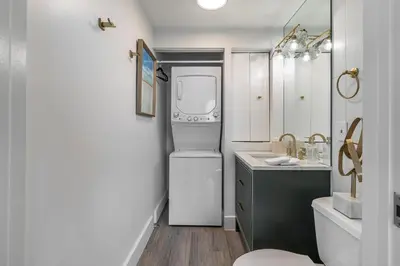 a small kitchen with a refrigerator and a sink at Bright 1BR in Coconut Grove King Bed Views Pool and Parking in Miami