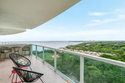 a balcony with chairs and a view of the ocean at Bright 1BR in Coconut Grove King Bed Views Pool and Parking in Miami