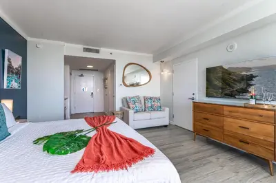 a bedroom with a bed with a dresser and a tv at Modern 3BR 3BA Grove Condo Views Balconies Full Kitchen 3 Parking in Miami