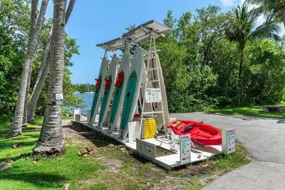 a lifeguard stand with a bunch of surfboards on it at Cozy Grove Stay Free Parking Pool Access Walk to Cafes and Parks in Miami