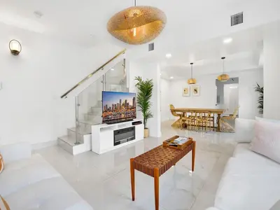 a living room with a couch and a tv at Casa Verde Design District 5BR Hot Tub in Miami