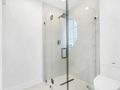 a glass shower in a bathroom with a toilet at Casa Verde Design District 5BR Hot Tub in Miami