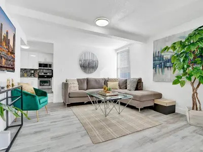 a living room with a couch and a table at Villa Bonita 6BR Pool Hot Tub Game Room in Miami