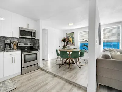a kitchen and living room with a table and a couch at Villa Bonita 6BR Pool Hot Tub Game Room in Miami