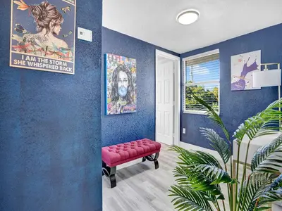 a room with a red bench in a room with blue walls at Villa Bonita 6BR Pool Hot Tub Game Room in Miami