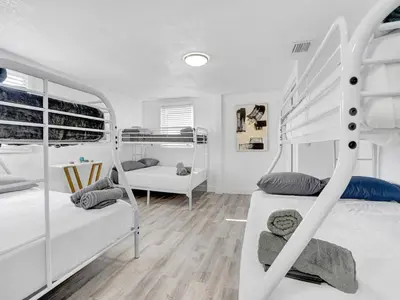 a bedroom with two bunk beds and a desk at Villa Bonita 6BR Pool Hot Tub Game Room in Miami