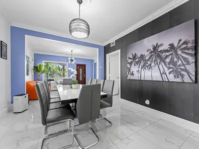 a dining room with a table and chairs at Villa Ciao Bella Sleeps 25 Pool Hot Tub in Miami