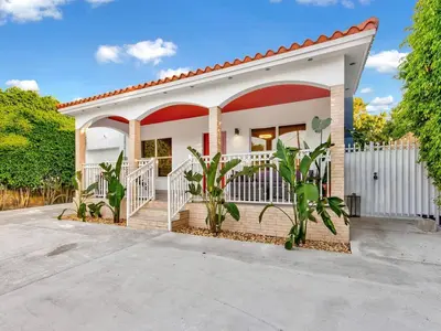 a house with a white and red roof at Villa Ciao Bella Sleeps 25 Pool Hot Tub in Miami