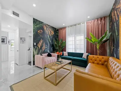a living room with a couch and a table at Villa mi Amor Walkable Pool & Games in Miami