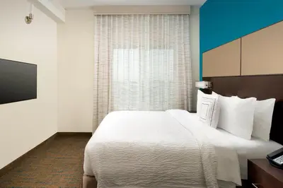a hotel room with a large white bed and a window at Residence Inn by Marriott Miami Airport West/Doral in Miami