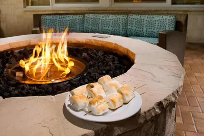a fire pit with two plates of food in front of it at Residence Inn by Marriott Miami Airport West/Doral in Miami