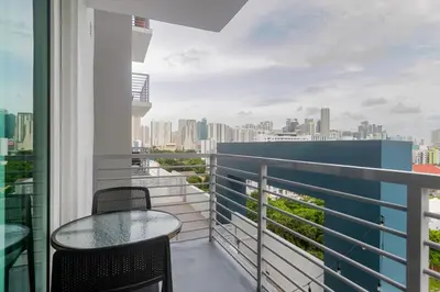 a balcony with a table and chairs and a city skyline at Blueground Riverside pool nr Miami River MIA-155 in Miami