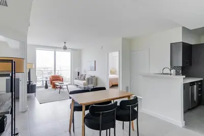 a kitchen and living room with a table and chairs at Blueground Riverside pool nr Miami River MIA-155 in Miami