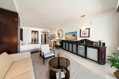 a living room with a couch and a table at Stunning Private Studio at Fontainebleau Sorrento - 802 in Miami Beach