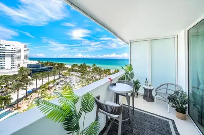 a balcony with a table and chairs and the ocean at Stunning Private Studio at Fontainebleau Sorrento - 802 in Miami Beach