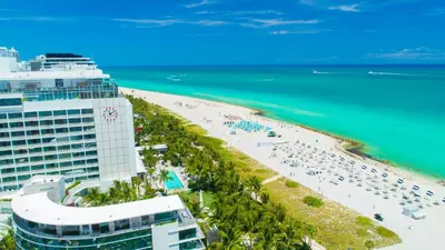an aerial view of a beach and the ocean at Stunning Private Studio at Fontainebleau Sorrento - 802 in Miami Beach