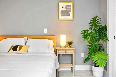 a bedroom with a bed and a table with a plant at Modern Studio Near Wynwood & Design District in Miami