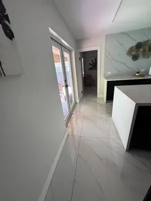 a living room with white walls and a marble counter at 12 Guest-In The Center of It All in Miami