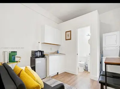a living room with a couch and a kitchen at HOT TUB and Washer & Dryer in Unit in Miami