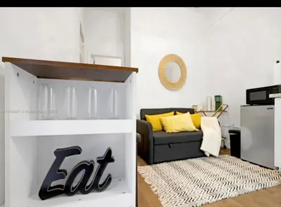 a living room with a black couch and yellow pillows at HOT TUB and Washer & Dryer in Unit in Miami