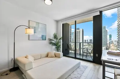a living room with a couch and a large window at High-Rise Luxury Condo in Downtown Miami with Ocean Views in Miami