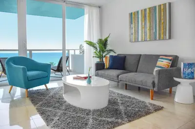 a living room with a couch and a table at Seacoast Suites on Miami Beach in Miami Beach