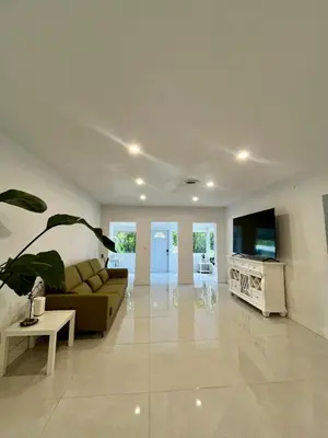 a living room with a couch and a tv at North Miami Vacation Home in North Miami Beach