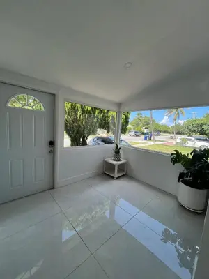 a white room with a door and a window at North Miami Vacation Home in North Miami Beach