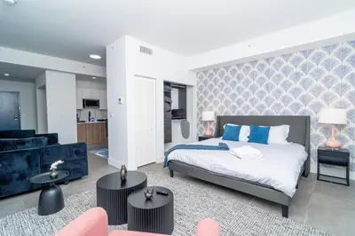a bedroom with a bed and a living room at MetroPark Hotel in Miami