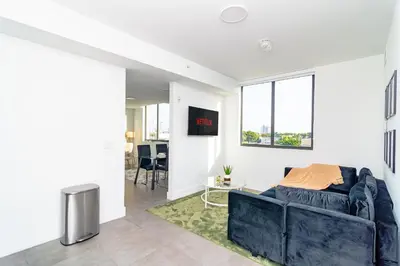 a living room with a couch and a large window at MetroPark Hotel in Miami