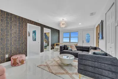 a living room with a couch and a table at The Pink Palm Little Havana Pool & Hot Tub in Miami