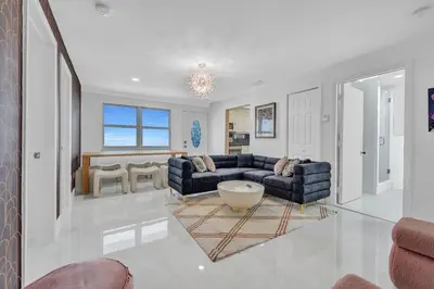 a living room with two couches and a table at The Pink Palm Little Havana Pool & Hot Tub in Miami