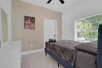 a bedroom with a large bed and a window at The Purple Paradise PoolHot Tub Little Havana in Miami