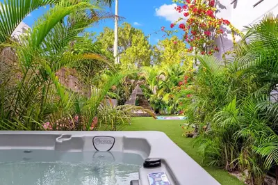 a bath tub in the middle of a garden at The Purple Paradise PoolHot Tub Little Havana in Miami