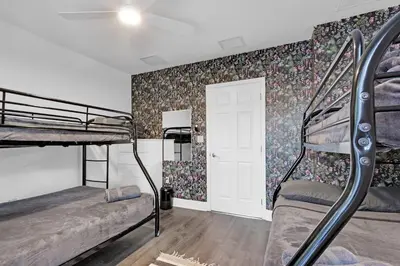 a bedroom with two bunk beds and floral wallpaper at The Purple Paradise PoolHot Tub Little Havana in Miami