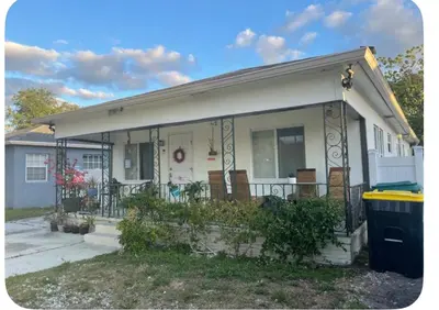 a house with a porch with chairs on it at Suite in Dania Beach in Dania Beach