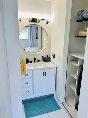 a bathroom with a white sink and a mirror at Villa Las Olas Designed with you in mind! in Fort Lauderdale