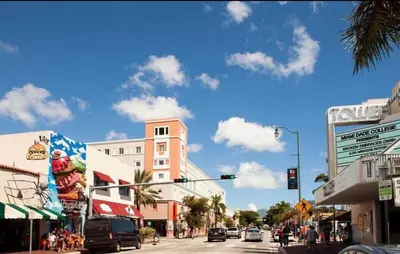a busy city street with a traffic light and buildings at The Vice City Suite - Private stay with Free Parking in the Heart of Miami in Miami