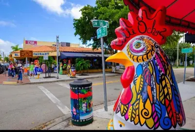 a chicken statue sitting on the side of a street at The Miami Tropic Suite - Private Stay with Free Parking in the Heart of Miami in Miami