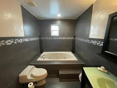a bathroom with a tub and a toilet and a sink at The Miami Tropic Suite - Private Stay with Free Parking in the Heart of Miami in Miami