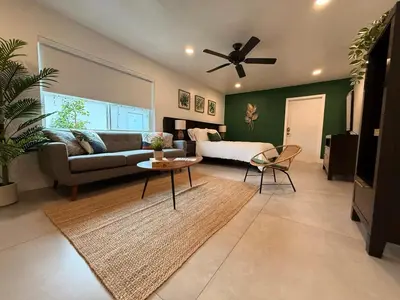 a living room with a couch and a ceiling fan at The Miami Tropic Suite - Private Stay with Free Parking in the Heart of Miami in Miami