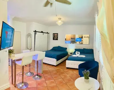 a living room with a blue couch and a table at south beach apartment 5 min walk to the ocean in Miami Beach