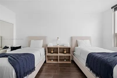 two beds sitting next to each other in a room at Midtown Miami Getaway-with pool n parking in Miami