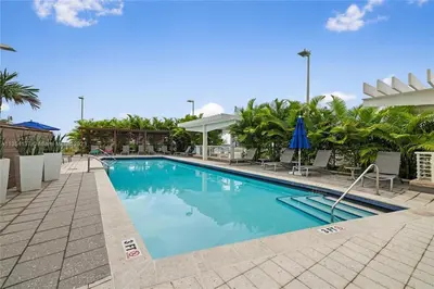 a swimming pool at a resort with blue water at Midtown Miami Getaway-with pool n parking in Miami
